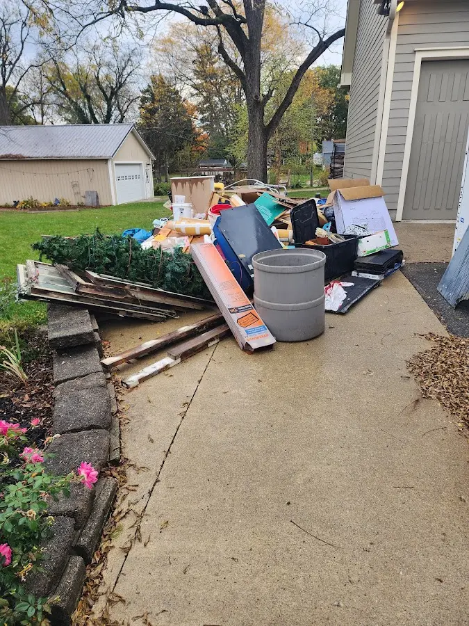 Dumpster being loaded with debris for Demolition Dumpster Rental in Bowling Green